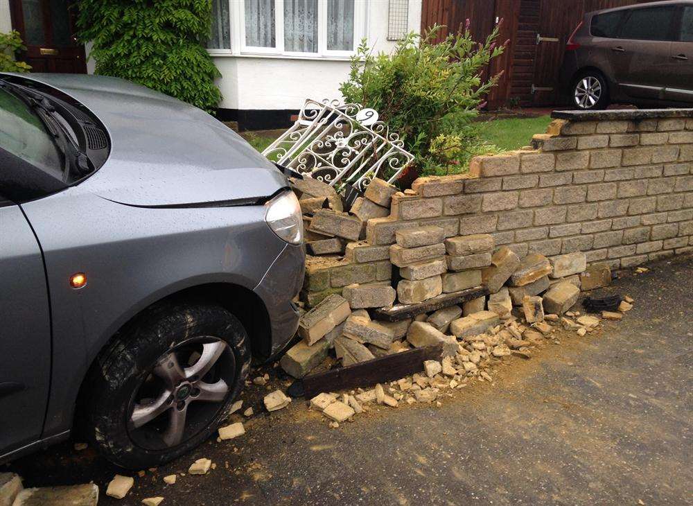 A garden wall and gate were badly damaged in Rochester
