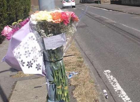 Floral tributes at the scene and tyre marks show where the car sped off