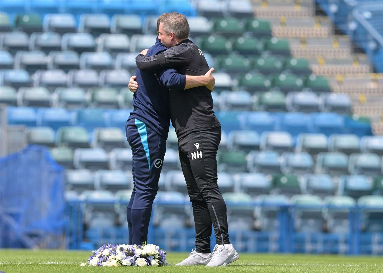 Managers Neil Harris and Gary Rowett embrace before the game. Picture: Keith Gillard