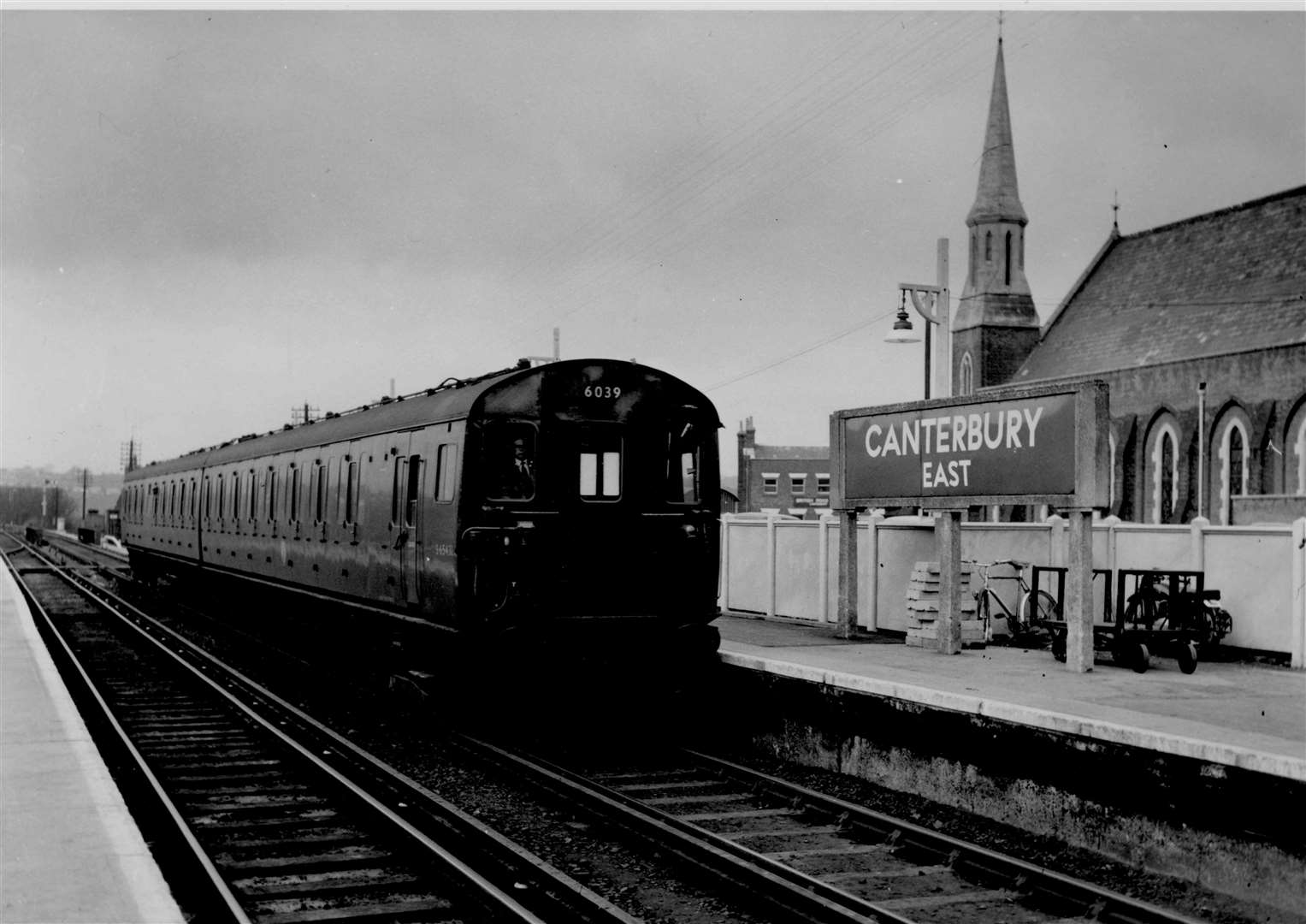The first electric train to run in east Kent returned to Canterbury East station after a trial trip to Selling in April 1959. The full service began in June. Note the spire of St Andrew's Presbyterian Church (since demolished) in the background