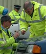 A full inspection is carried out on one of the vehicles stopped. Picture: GARY BROWNE