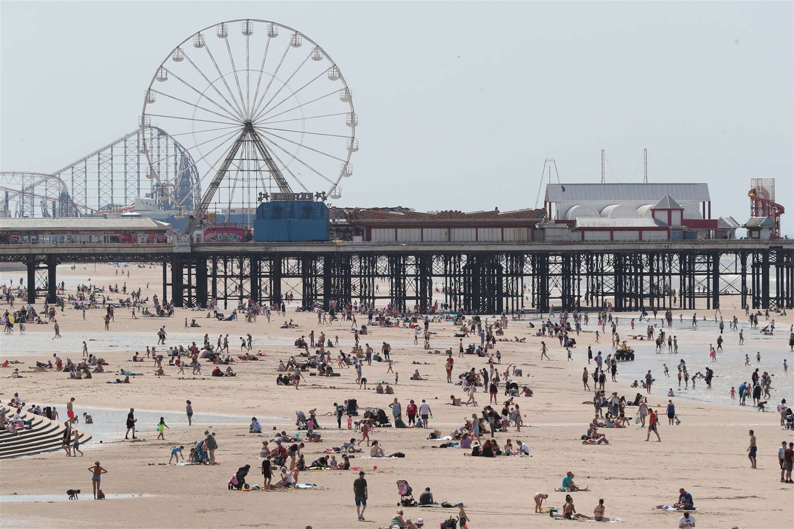 People enjoy the hot weather at Blackpool beach (Peter Byrne/PA)