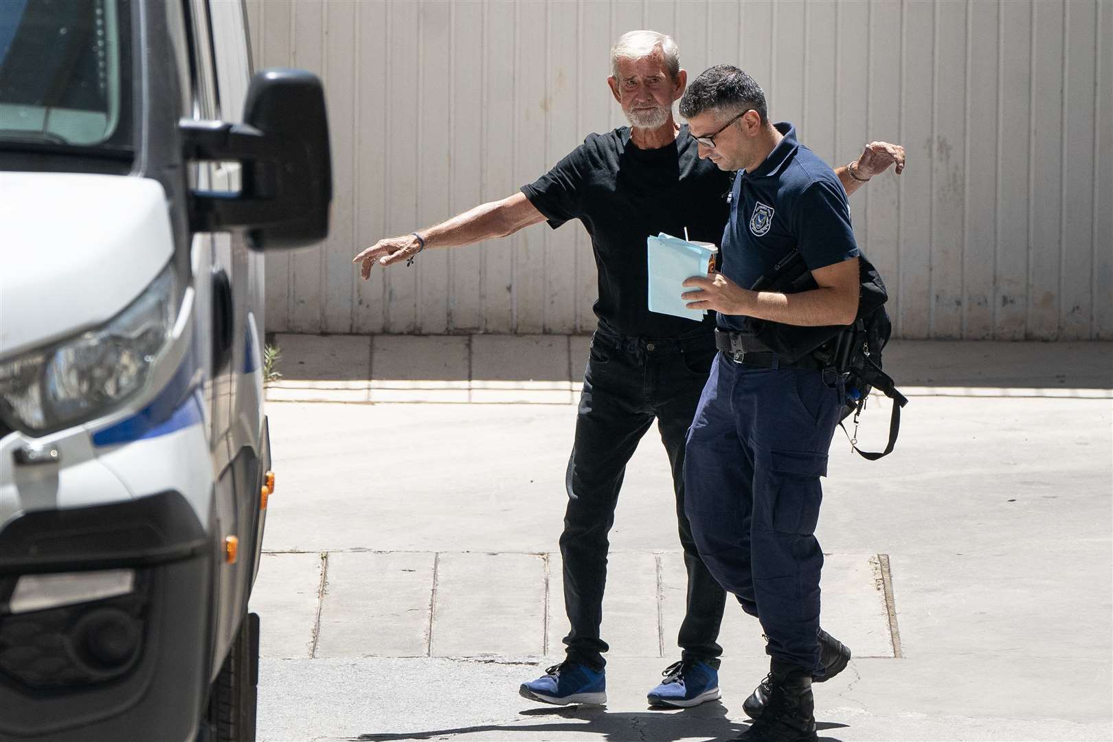 David Hunter is transported from court in Cyprus after he was found guilty of the manslaughter of his terminally ill wife (Victoria Jones/PA)