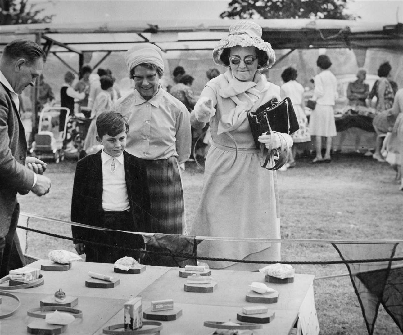 Mick Cheesman pictured aged eight, watching Lady d'Avigdor-Goldsmid playing hoopla at the Five Oak Green village fete in 1962