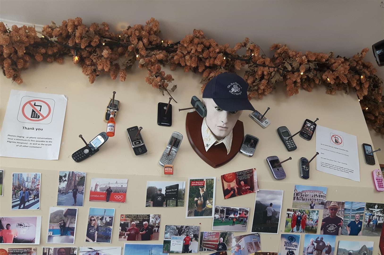 The rules about phone use are displayed on the main wall inside the micropub (3600963)