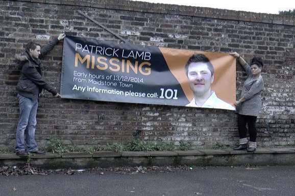 Pat Lamb's brother Paul holding a missing person's banner with mother Sharon