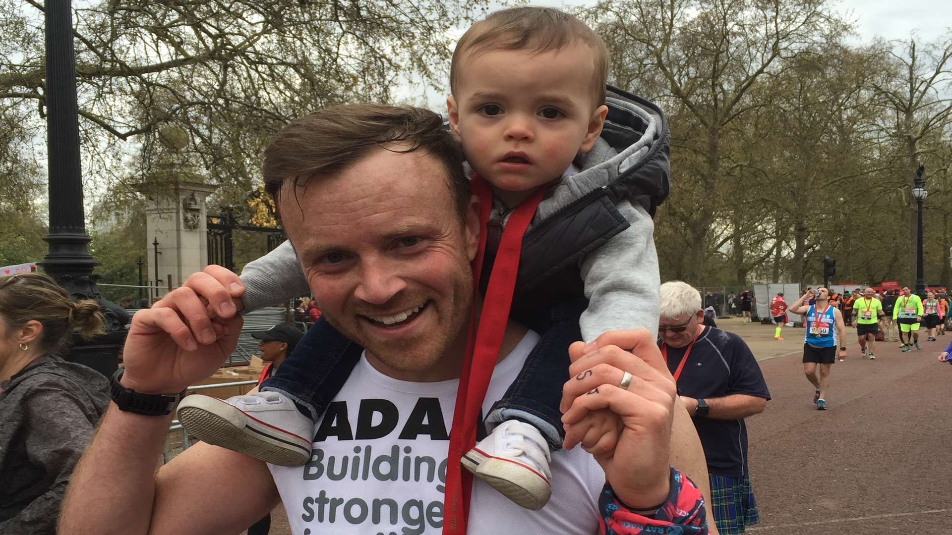 Adam carried Joshua across the finish line at the marathon on his shoulders