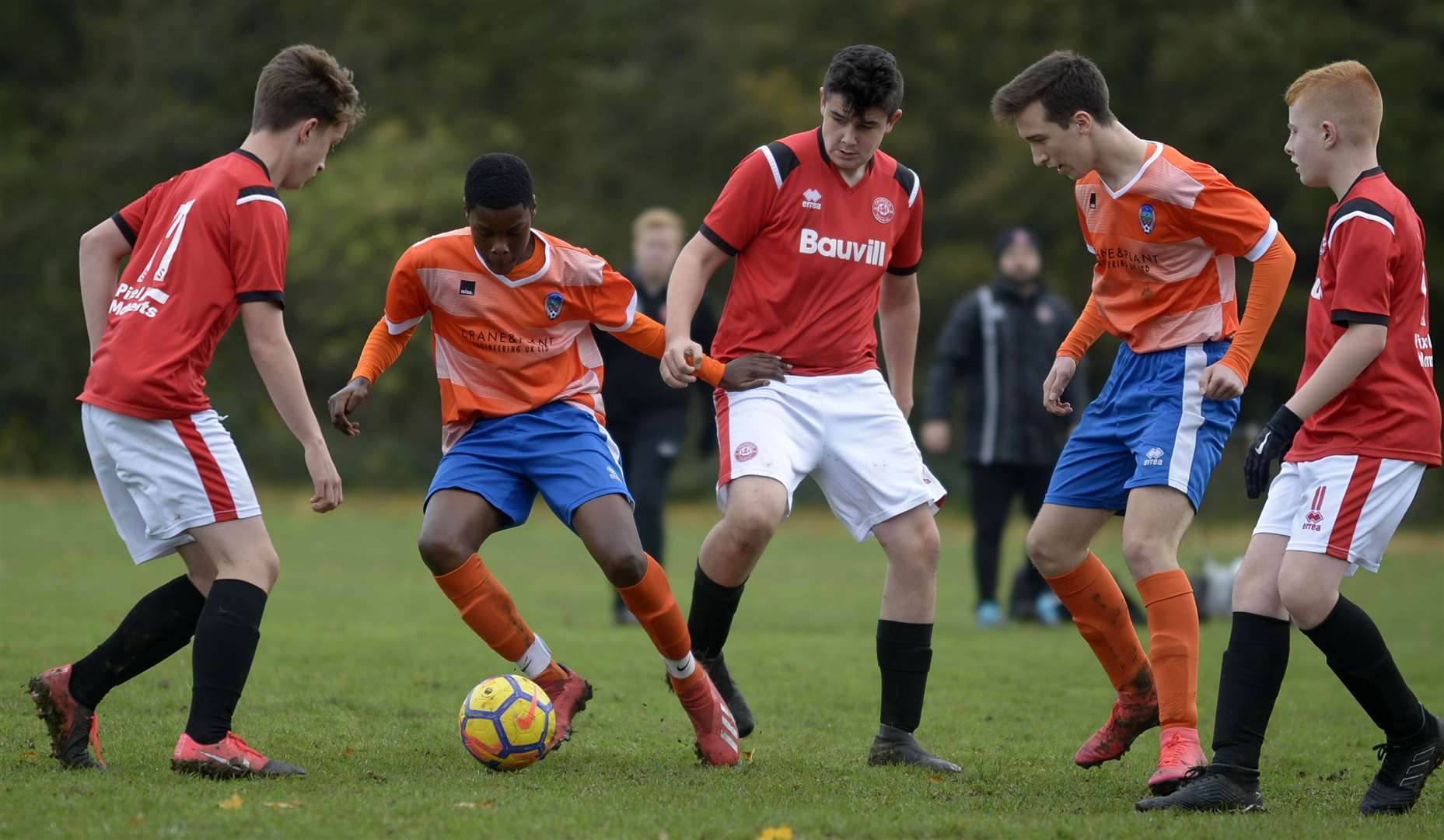 Cuxton under-15s (orange) try to find some space against Chatham Town under-15s. Picture: Barry Goodwin (42936780)