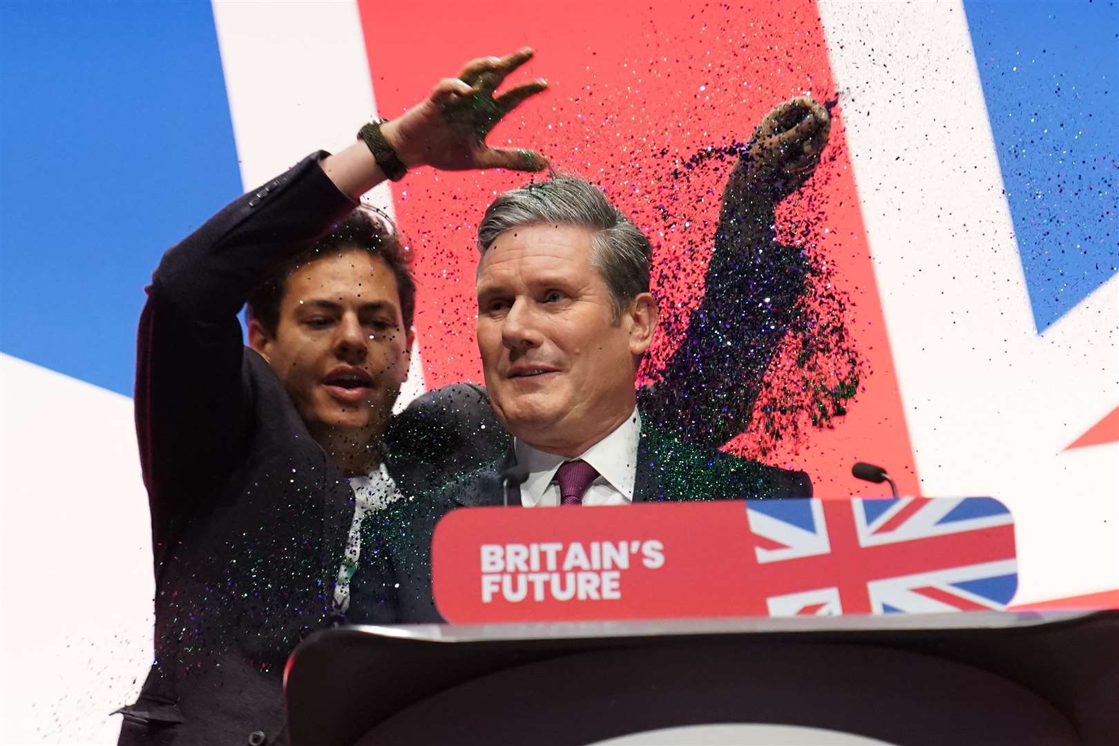 A protester disrupts Sir Keir Starmer’s speech and throws glitter on the Labour leader (Stefan Rousseau/PA)