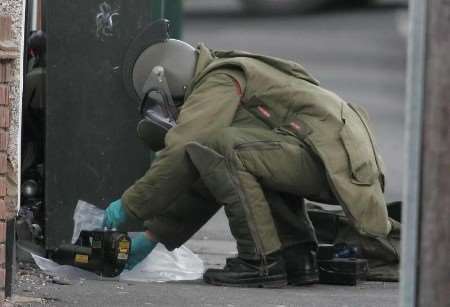 A bomb disposal officer deals with the package. Picture: PETER STILL