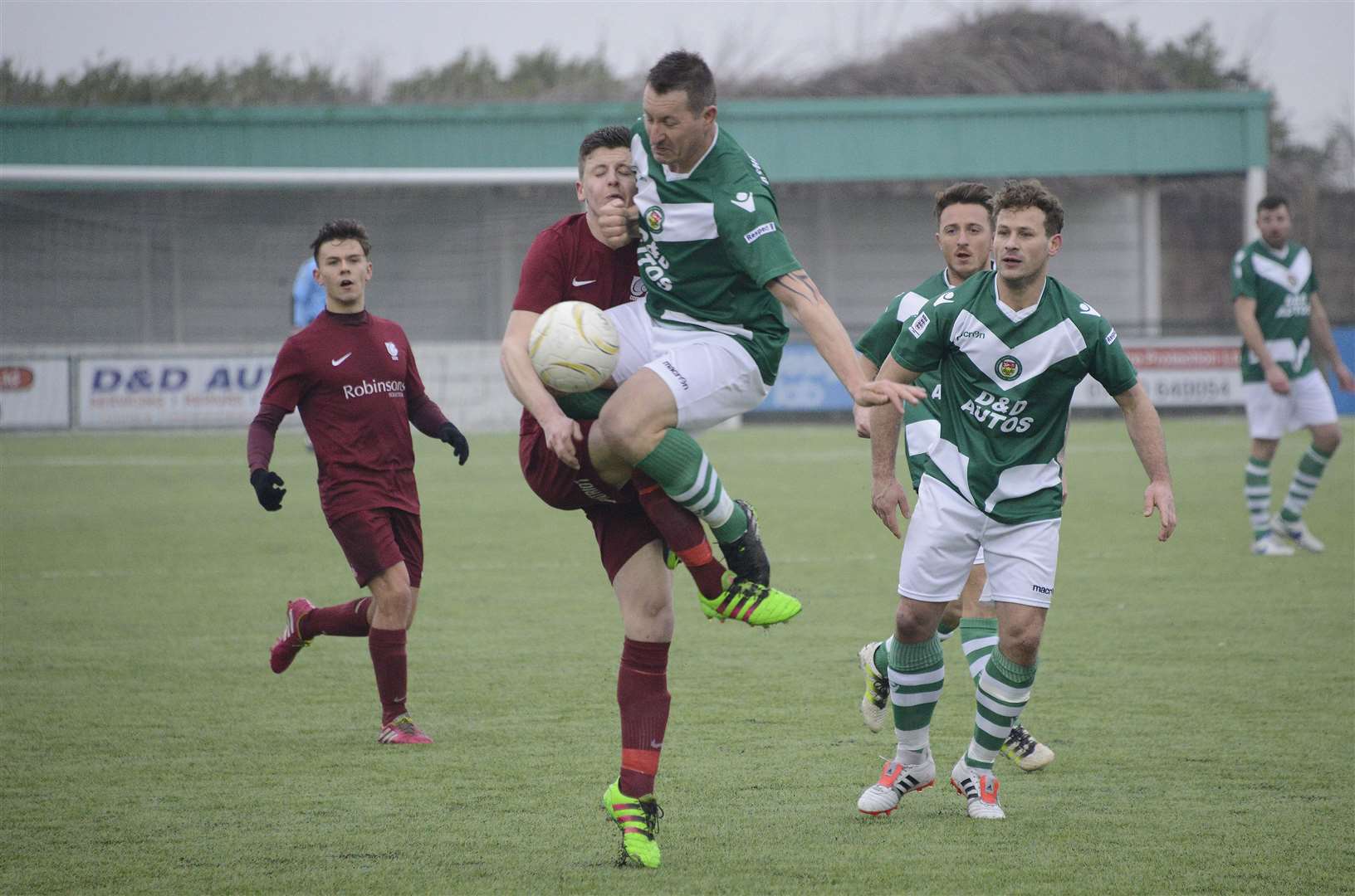 Alfie Nunn (left, in burgundy) competing for the ball during a game against Ashford