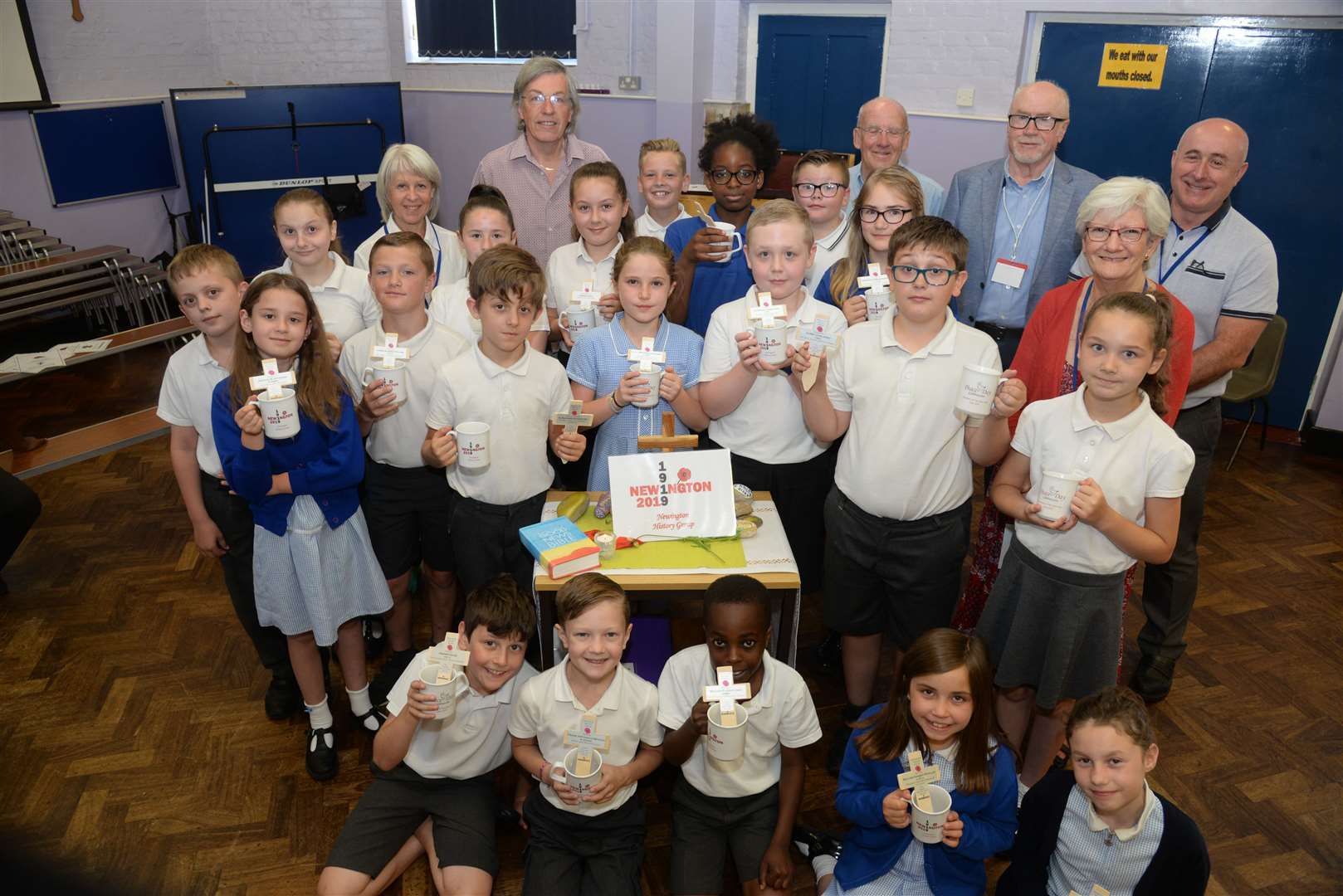 Members of the Newington History Group with pupils and their Peace Day mugs at Newington CE Primary School. Picture: Chris Davey (13441701)