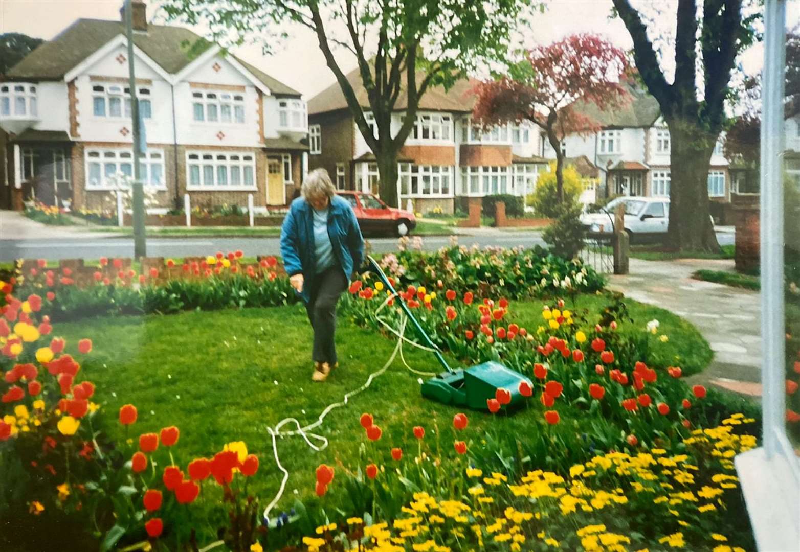 Winifred Flemming mowing her garden Picture: SWNS