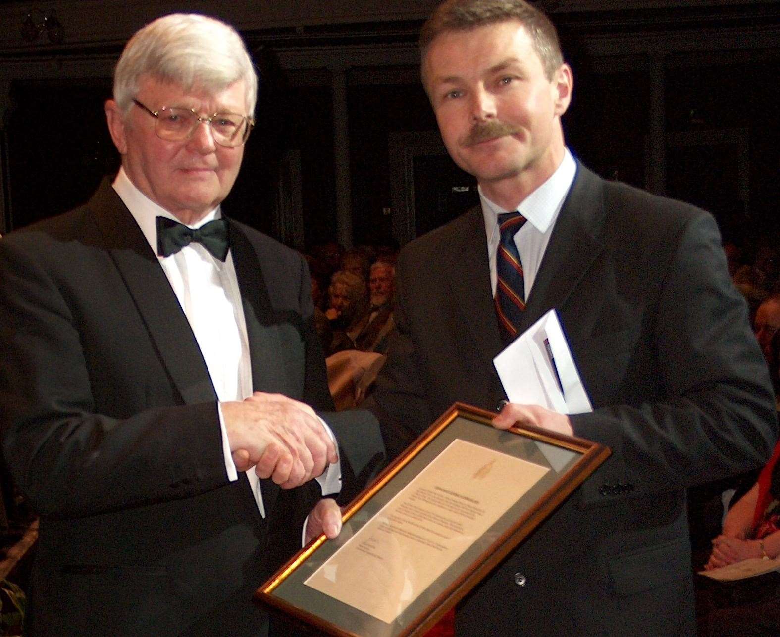 Principal Director of Music Royal Marines Lt Col Chris Davis, on the right, presents Lt Co Paul Neville with the Commandant General's Commendation in 2005. Picture: Steve Misson