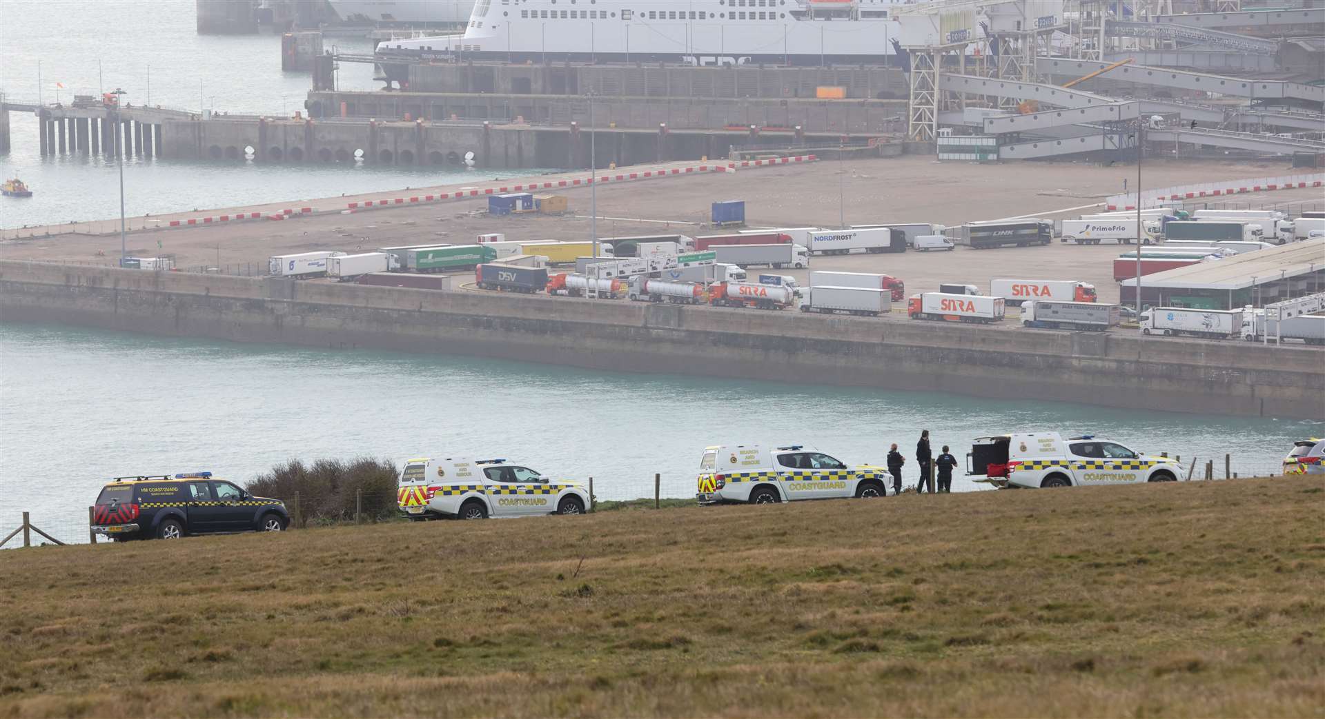 Several vehicles and officers are on the cliff top. Picture: UKNIP