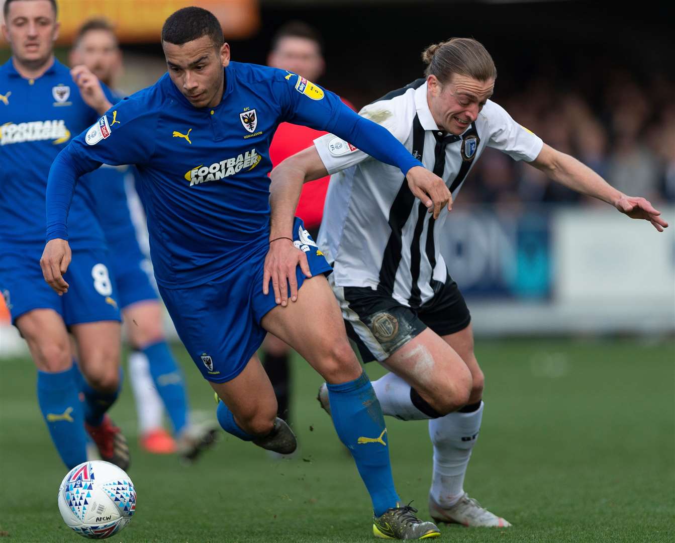Tom Eaves tangles with AFC Wimbledon's Rod McDonald Picture: Ady Kerry