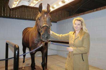 Ksenia Jones with a horse in the equestrian solarium