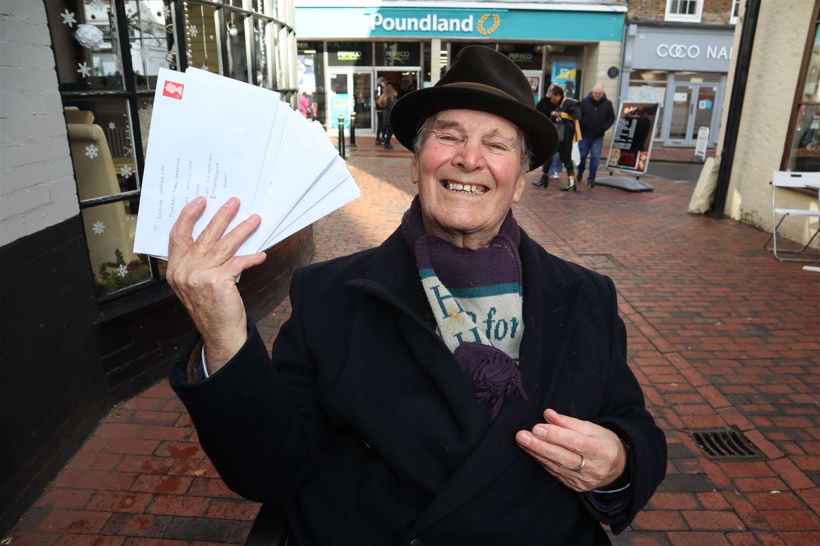 Sittingbourne's 'whistling postman' Dale Howting, pictured with some of cheques he will be posting