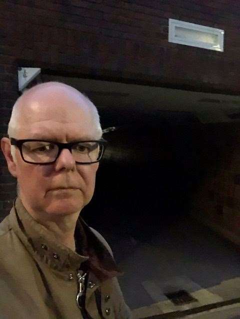 Stuart Jeffery stands in front of the darkened subway
