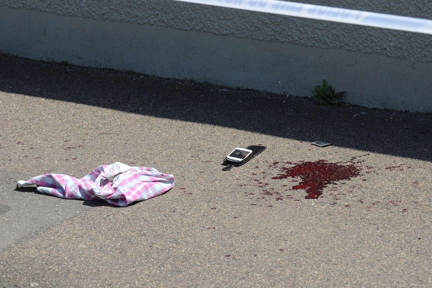 A pool of blood at the scene of the stabbing