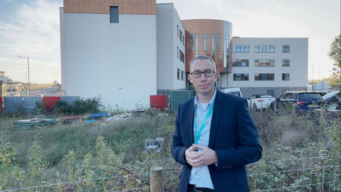 Graham Razey outside the empty site where the new building could stand. Photo: EKC