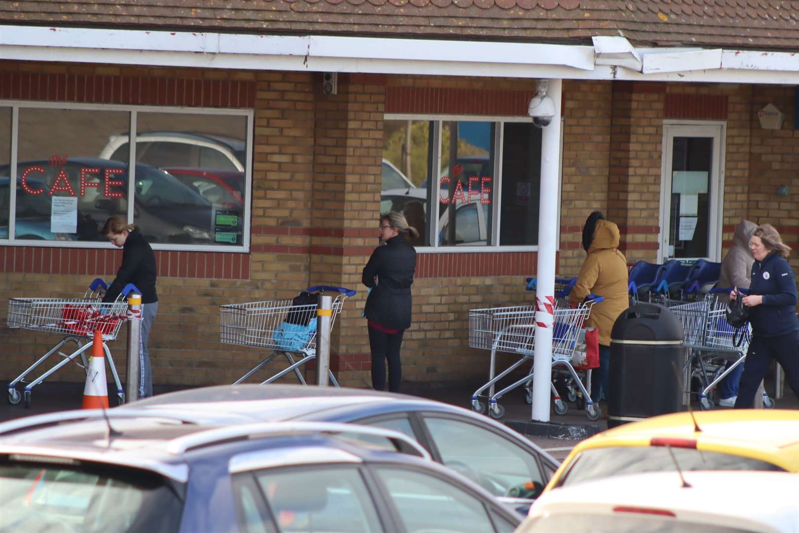 NHS workers queuing two metres apart outside Tesco because of the coronavirus scare