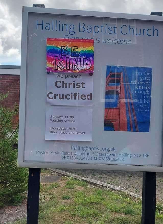 Elizabeth Kitchener's 'Be Kind' poster placed over the sign, which previously said "We don't celebrate Pride"