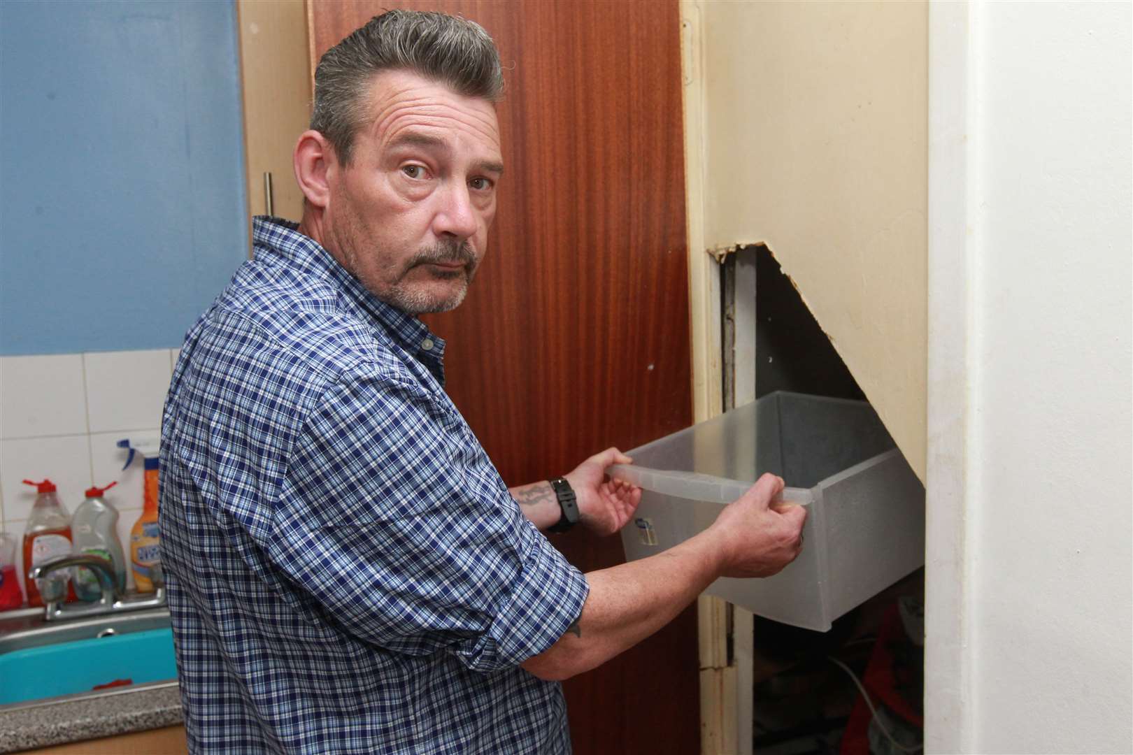 Stephen Care is extremely worried about the electrics coming into contact from leaky pipes from the water tank in his flat. Picture: John Westhrop. (11079375)
