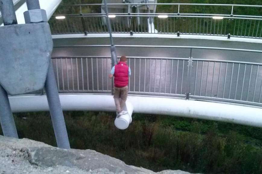 Boy pictured climbing on edge of Eureka Skyway bridge at Ashford over ...