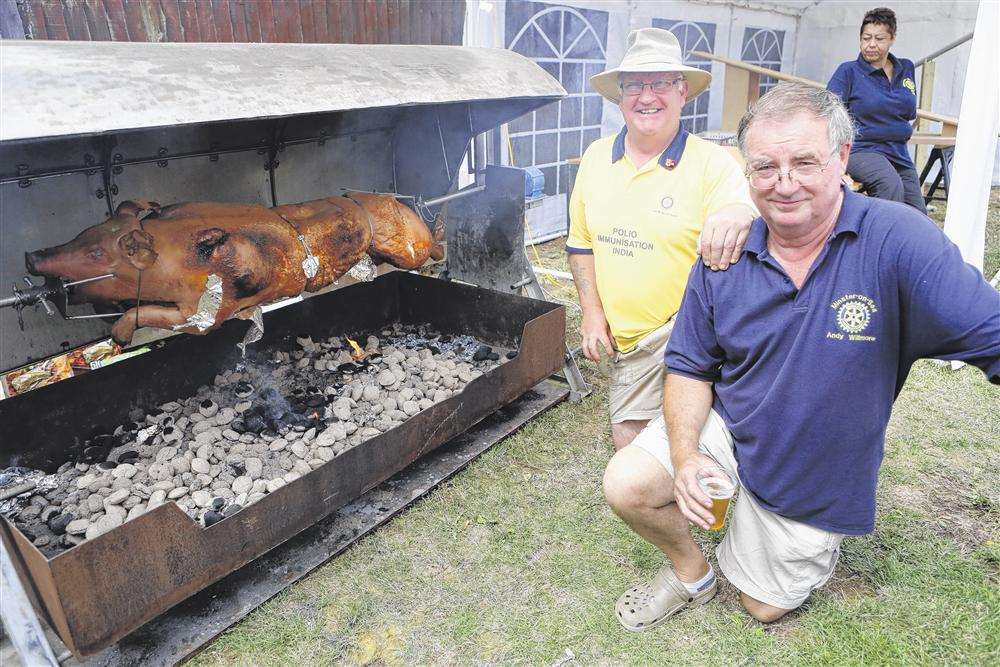 Rotary club members Ray Seager and Andy Willmore with the hog roast