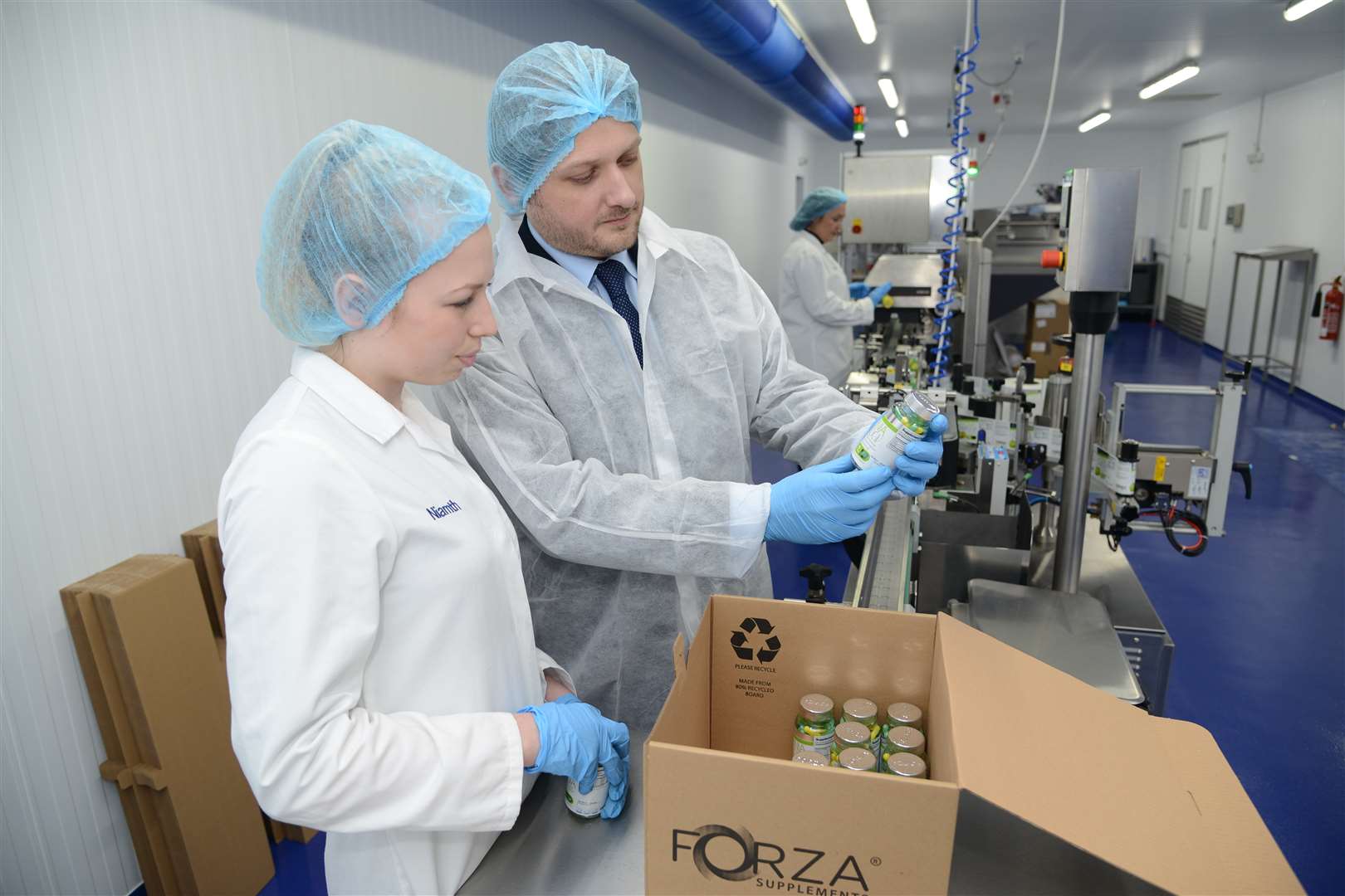 Lee Smith with production assistant Tilly Hart in the bottling and labelling area of Forza Supplements