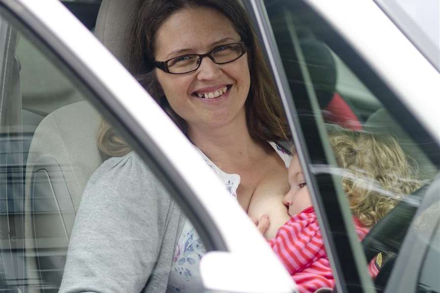 Mardi breastfeeds two-year-old Olivia in a car