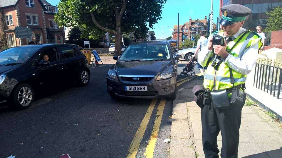 A warden standing close to the vehicle. It is understood it was given a parking ticket. Picture: Facebook