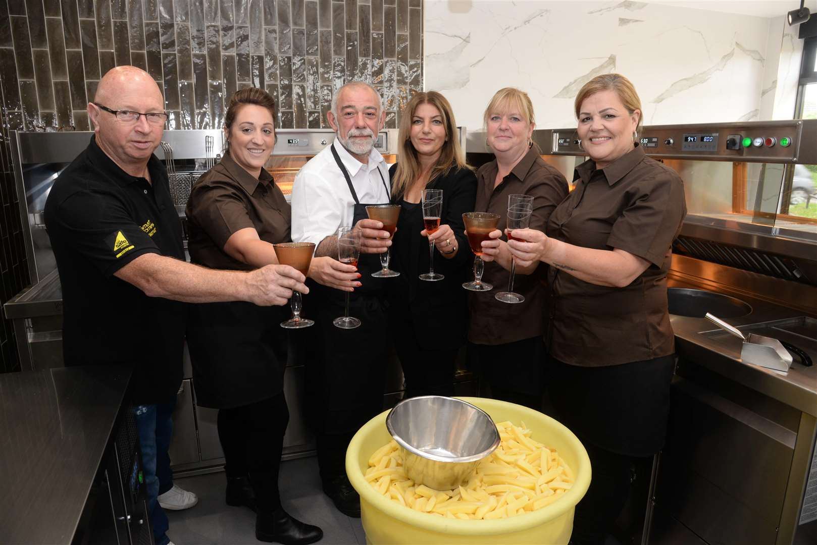Kikis and Julia Mathelu and staff at the re-opening of Papa's fish and chip shop in Beatty Road, Rochester on Thursday. Picture: Chris Davey (2310606)