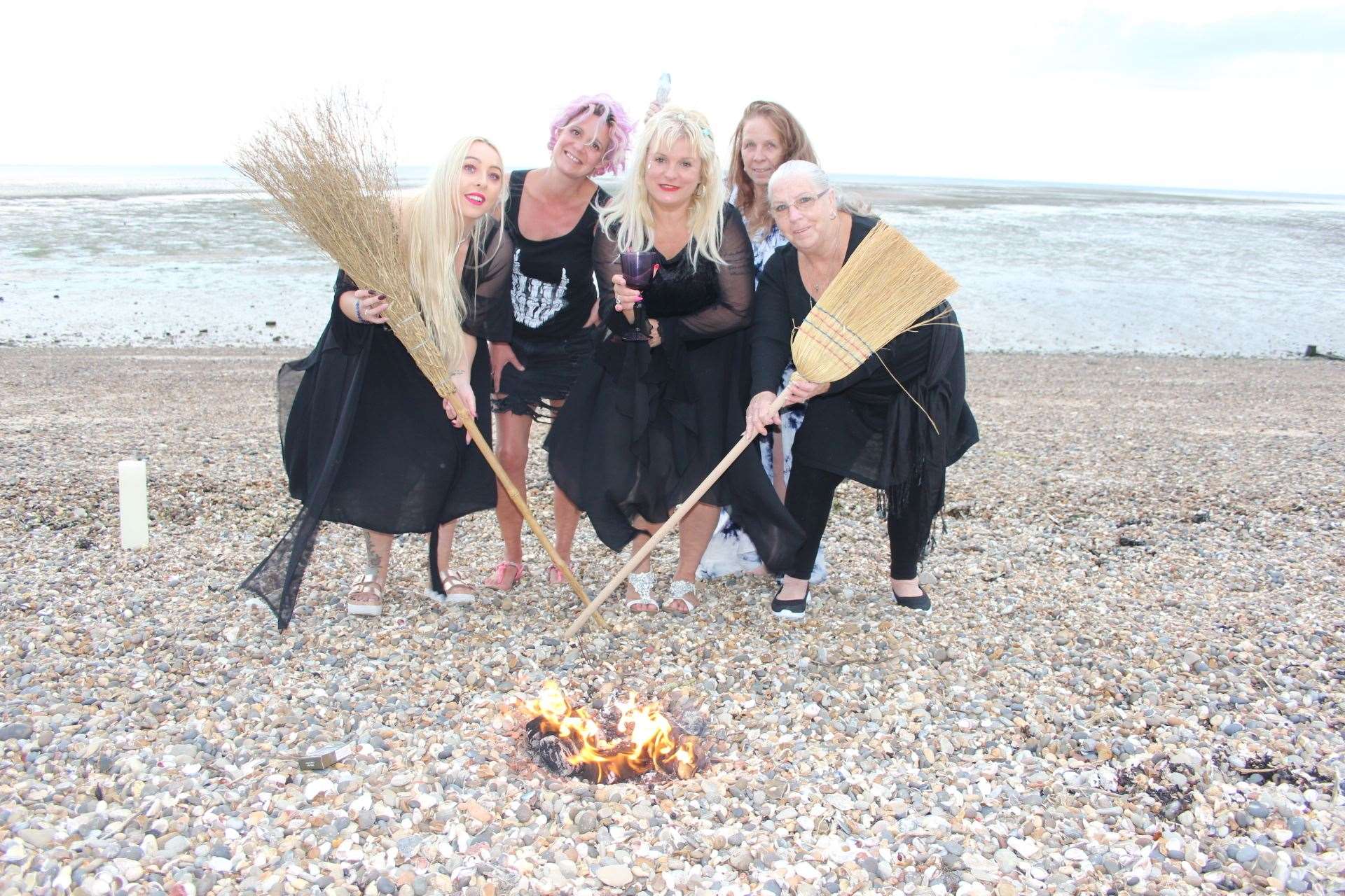 Sheppey's 'Witches of Eastchurch' with Charlotte Clark, centre, having a spell on the beach at Minster. Picture: John Nurden