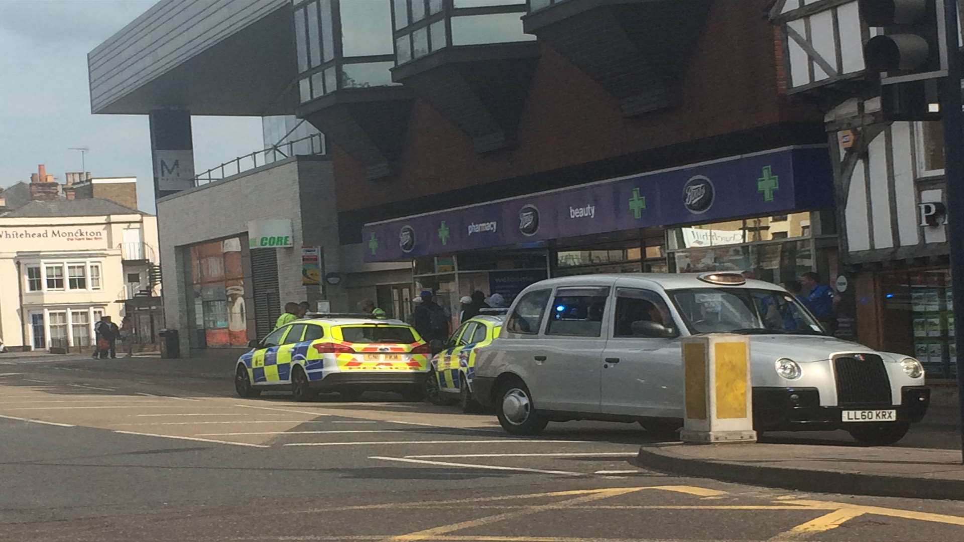 Two police cars were seen parked outside Boots in King Street, Maidstone
