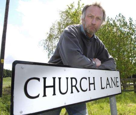 Geoff Cornes with the Church Lane - or is it Road? - sign in Kenardington