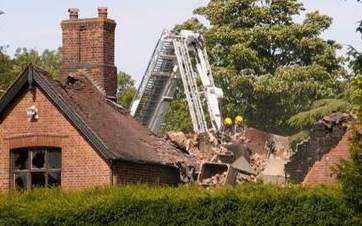 The Promis Recovery Centre Nonnington as firemen make the roof safe after the fire