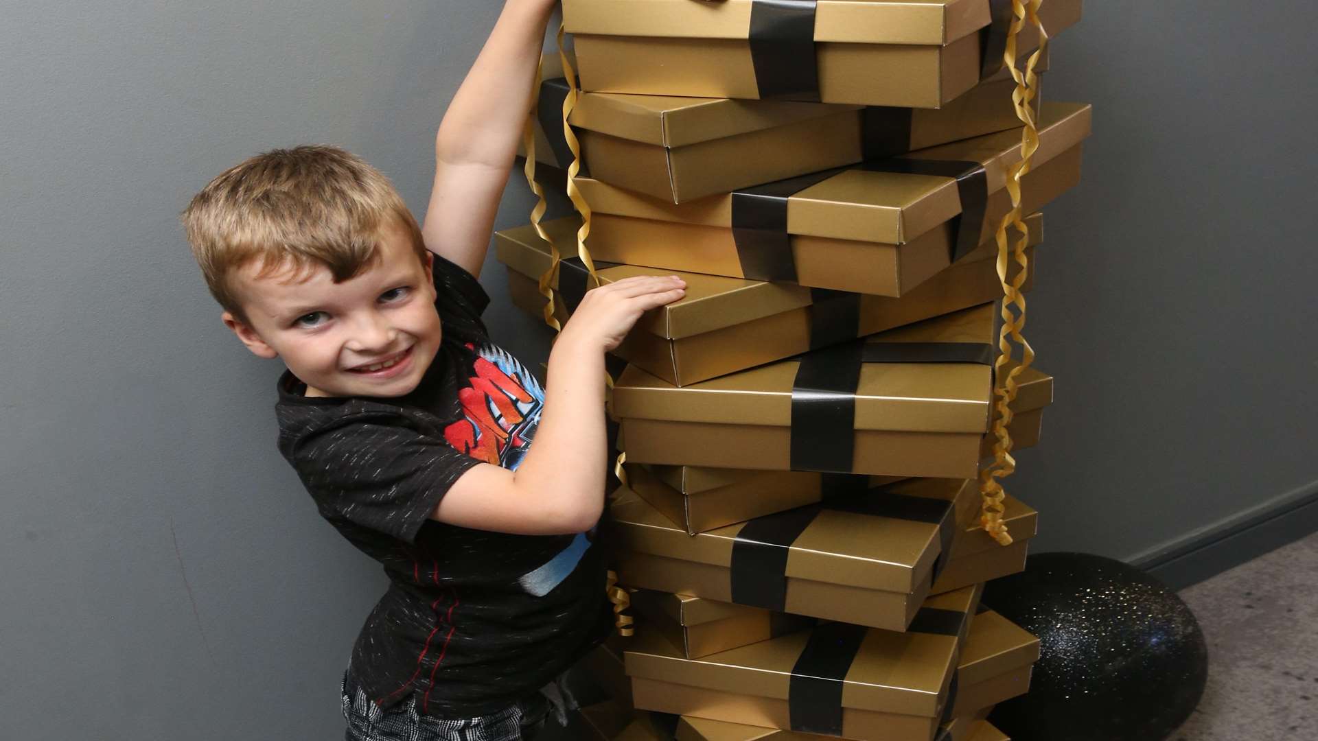 Aidan Louch, seven, checks out the decoration gift boxes at Village Hotel's Yule Fest