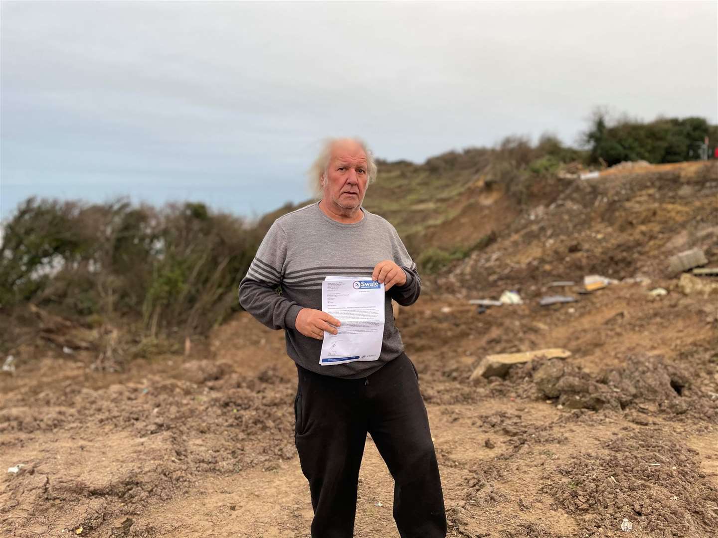 Malcolm Newell, of Surf Crescent, Eastchurch, with the stop notice from Swale council