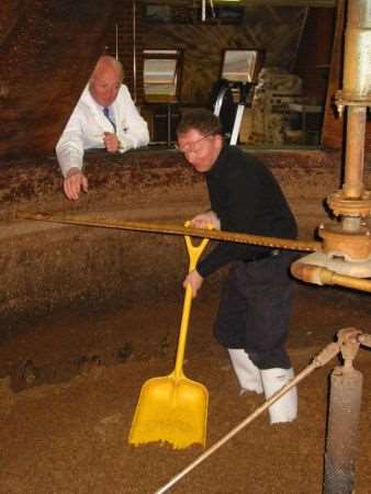 Stuart in the mash tun shovelling out the old grain