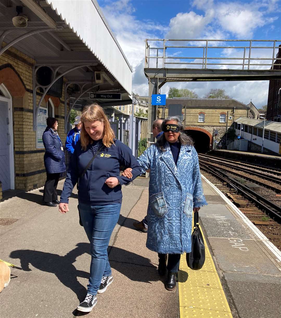 Cllr Shellina Prendergast is guided along the platform at Maidstone East