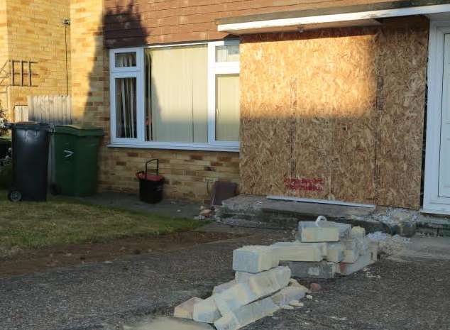 The house has been secured with boards. Picture: Martin Apps
