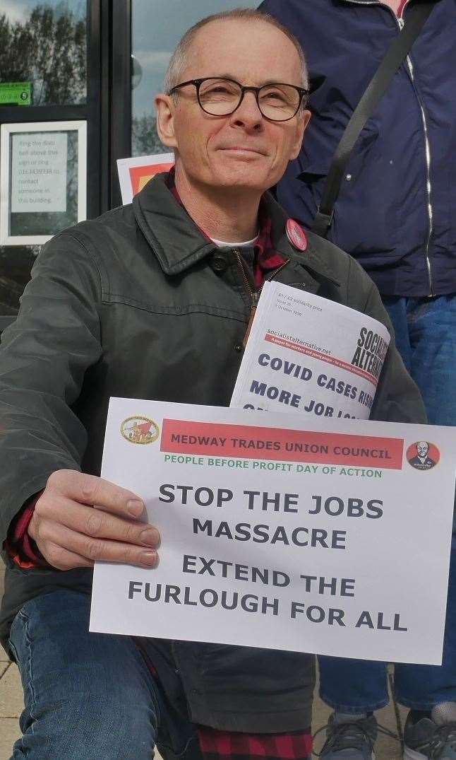Chas Berry, front, stands with supporters calling for more support for workers. Picture: Medway TUC