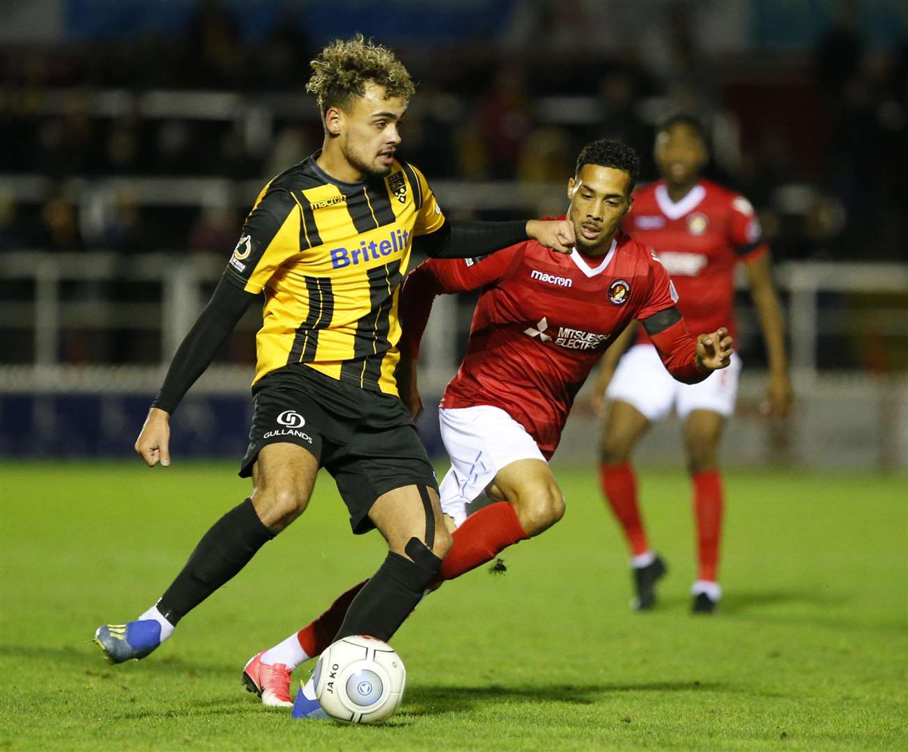 Action from the derby as Maidstone midfielder Michael Phillips goes up against Corey Whitely Picture: Andy Jones