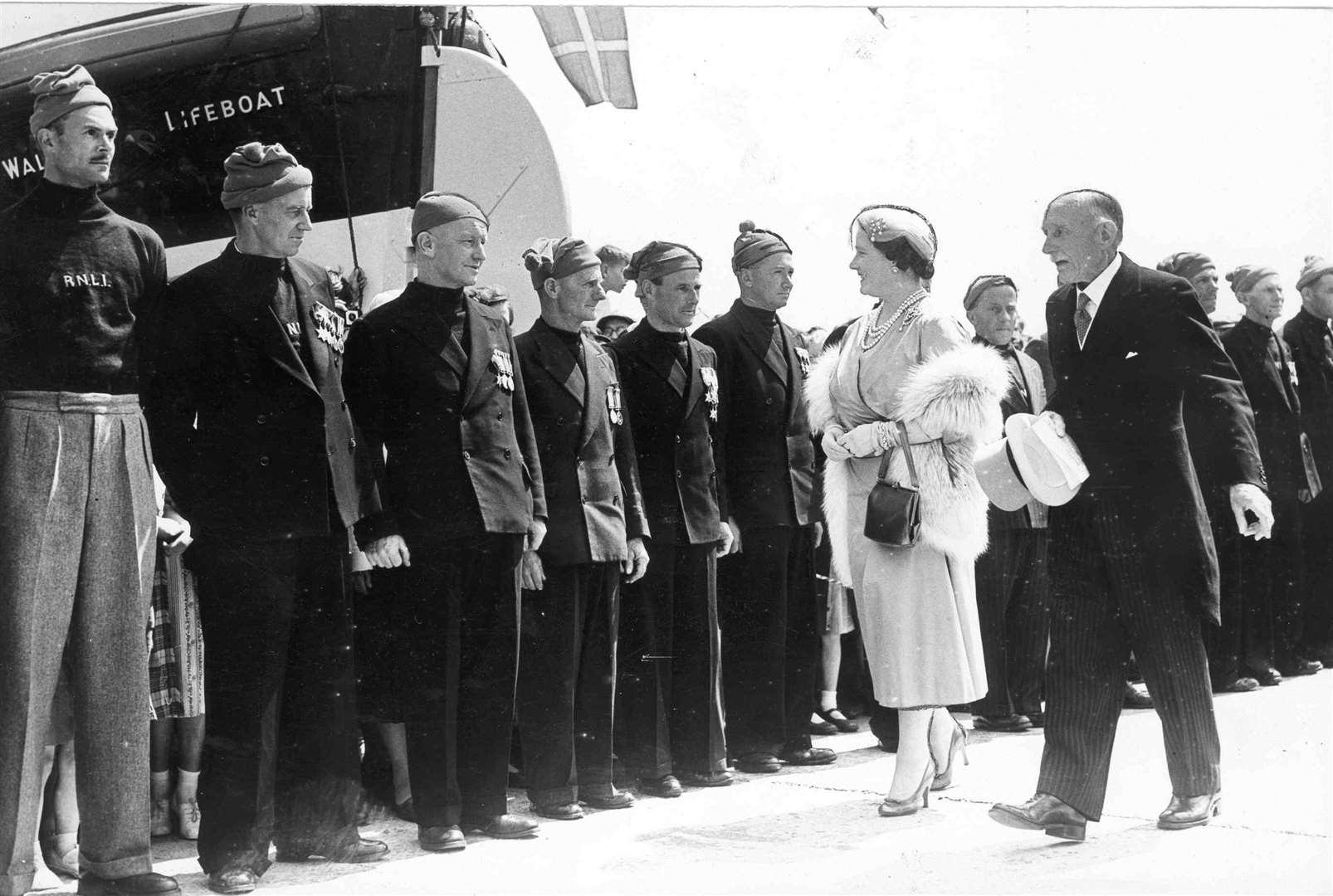 The lifeboatmen of Walmer lined up to welcome the Queen Mother when she arrived at the station to present a certificate to mark its centenary in May 1956. The same day she opened an accommodation block at the Royal Marines Depot at Deal