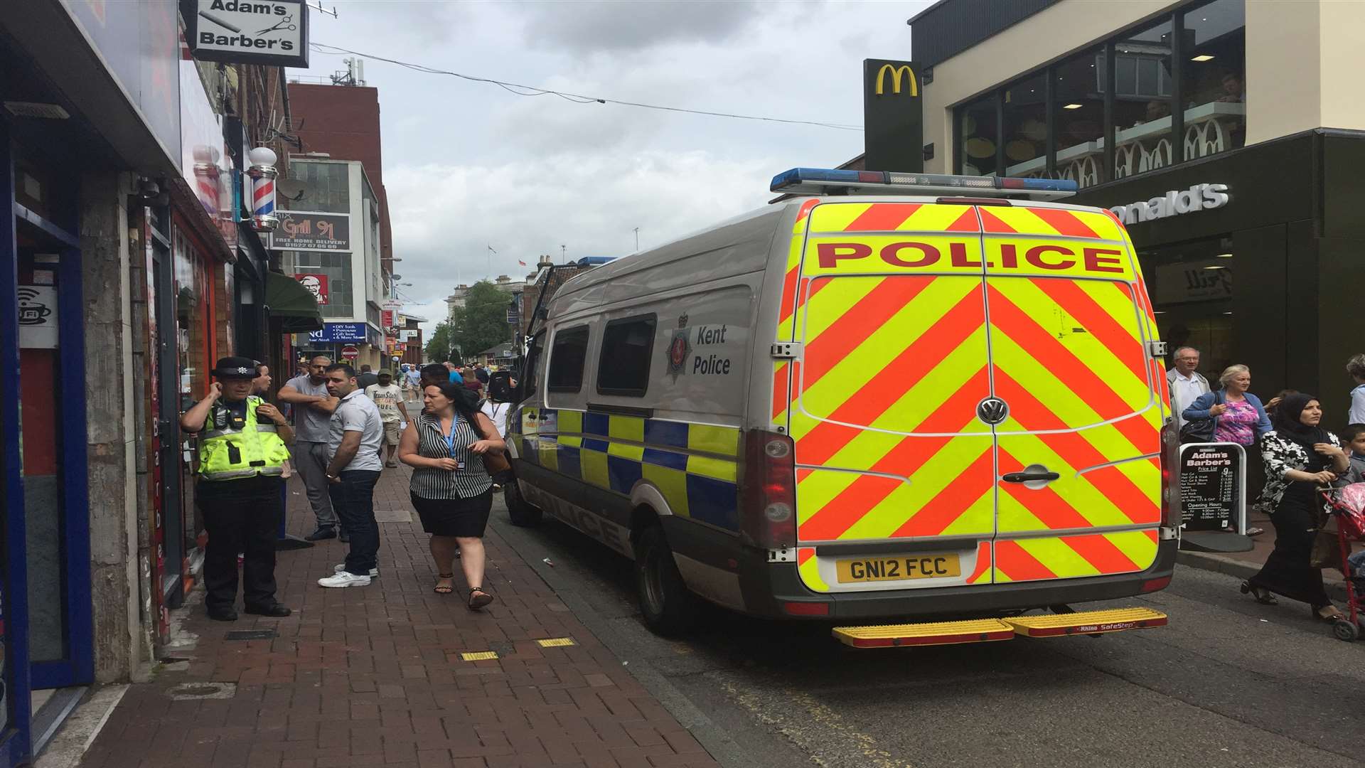 More than a dozen police and immigration officers stormed the barbers