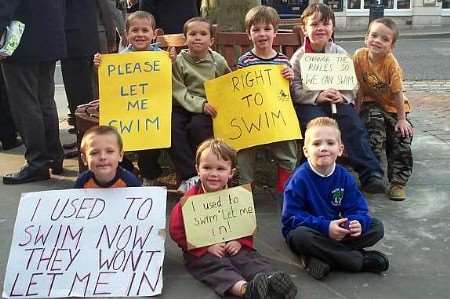 Children protest about the new swimming rules ahead of the council meeting