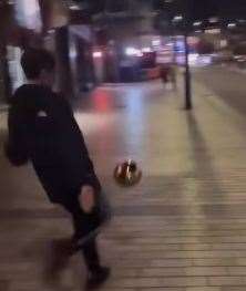 One of the boys kicking the ornamental ball from Cheran's bakery down Maidstone High Street. Picture: Cheran’s Bakery