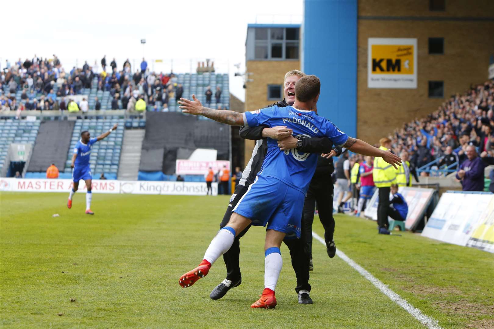 Ady Pennock embraces Cody McDonald after he scores two crucial goals against Bristol Rovers Picture: Andy Jones